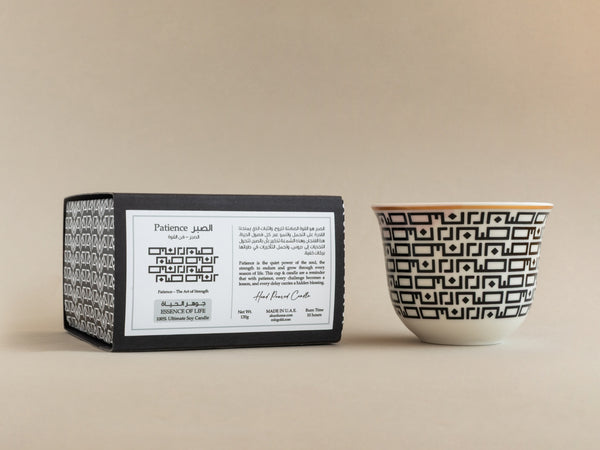AKUN Essence of Life candle featuring the Sabr (patience) Arabic design in a handcrafted ceramic cup beside its presentation box