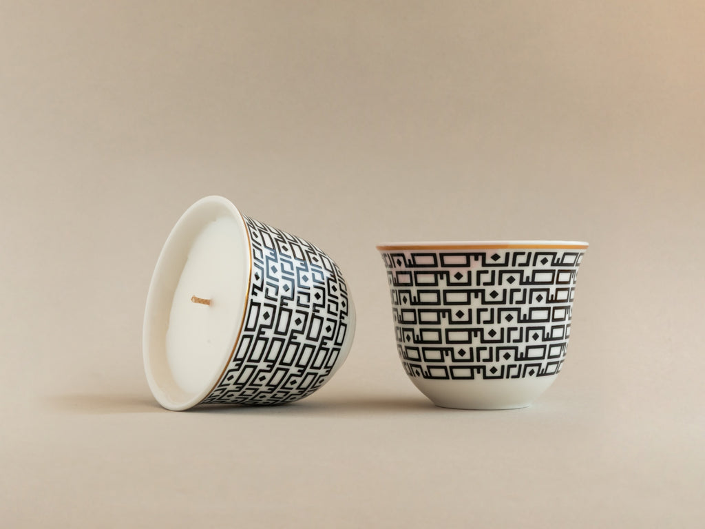 Detail view of AKUN Essence of Life Sabr candle cups highlighting the Arabic patience pattern and ceramic craftsmanship