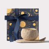 Moon-inspired Noor Al Qamar sculpted candle by AKUN presented with celestial illustrated gift box and ribbon