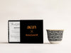 AKUN x RolzGold Essence of Life candle featuring the Baraka design, shown with collaborative packaging and an Arabic-inspired patterned cup on a white background