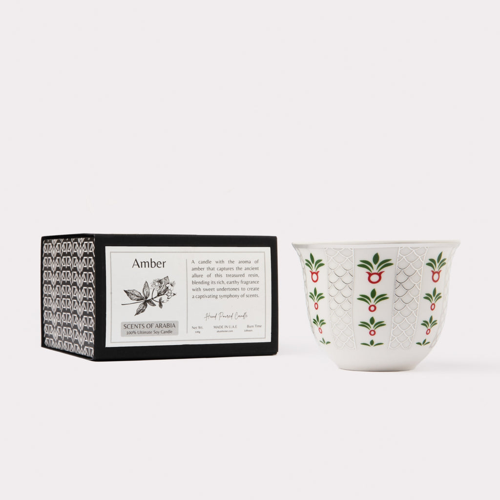 AKUN Scents of Arabia amber fragrance candle displayed as a minimalist still life with ceramic cup and boxed presentation