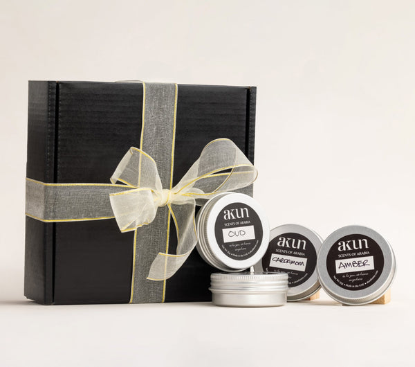 AKUN Scents of Arabia candle discovery gift set styled with ribboned black box and assorted fragrance tins